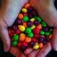 skittles in hands